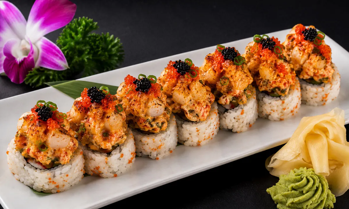 Mr. Krab Roll topped with baked seafood, roe and green onions